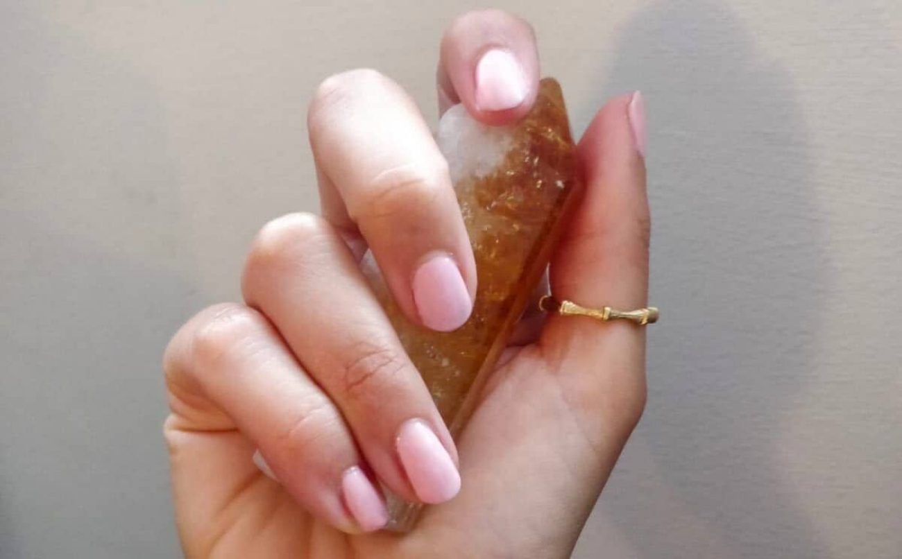 hand holding Citrine wearing gold thumb ring