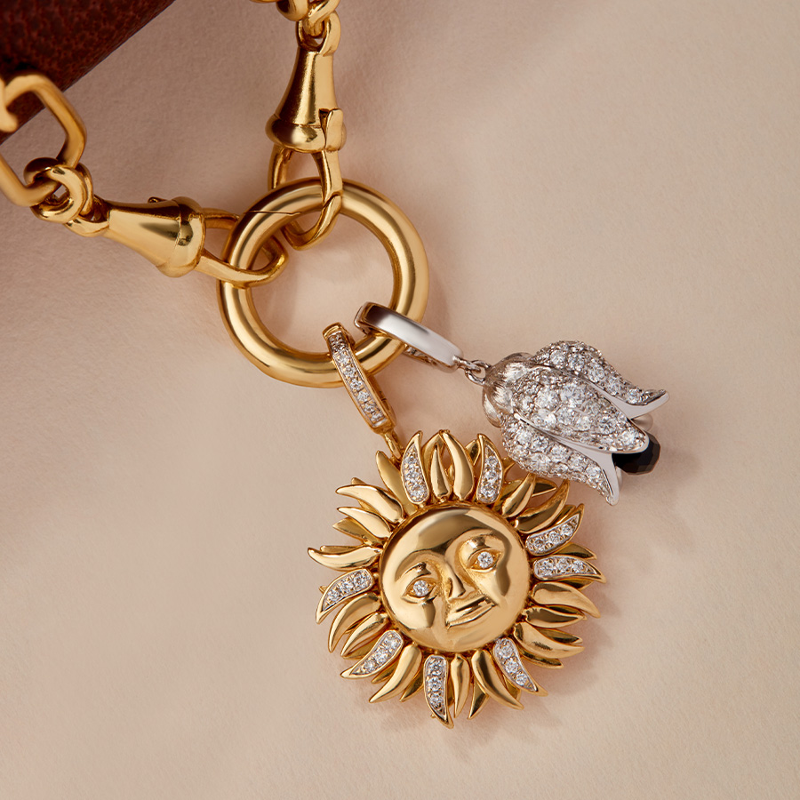 18ct gold sun charm and tulip charm on chain
